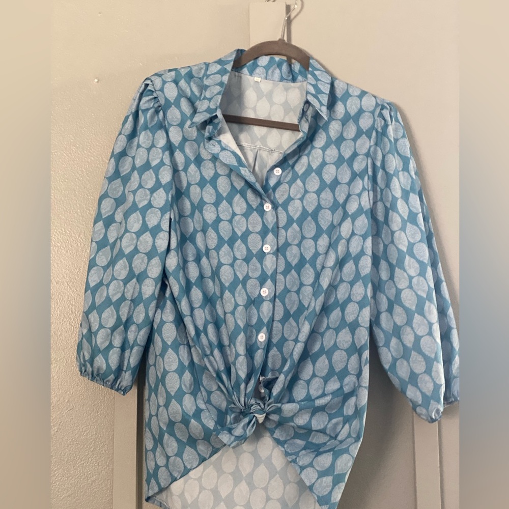 Woman’s blue shirt with lighter blue tearlike dots